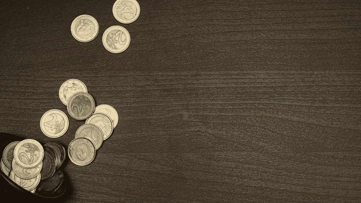Gold coins scattered across a surface.