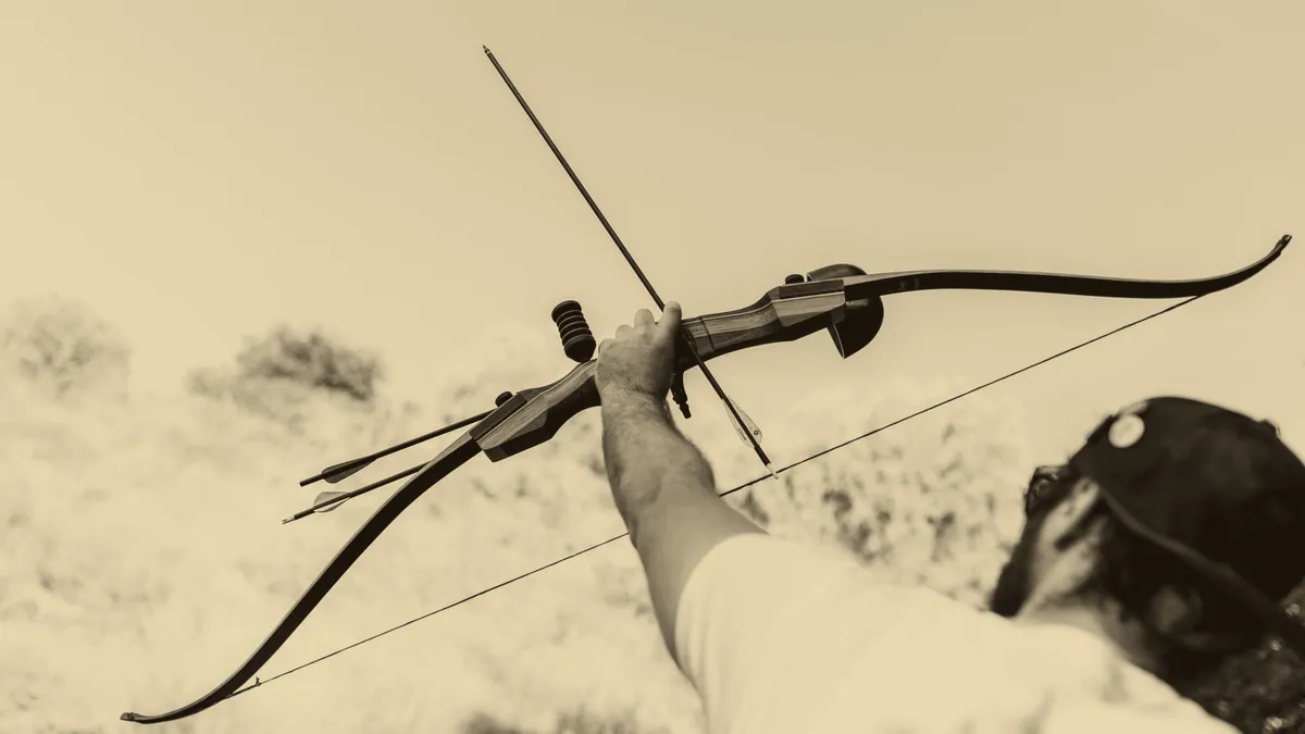 A drawn bow in the woods.