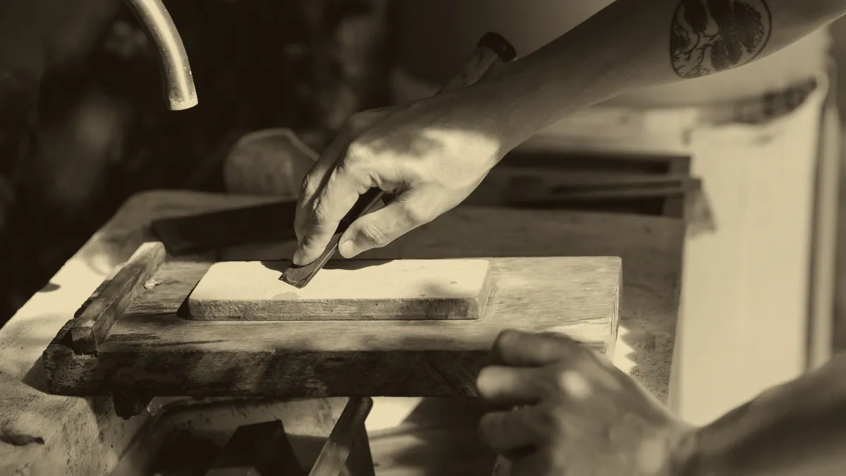 A blade drawn across a whetstone.