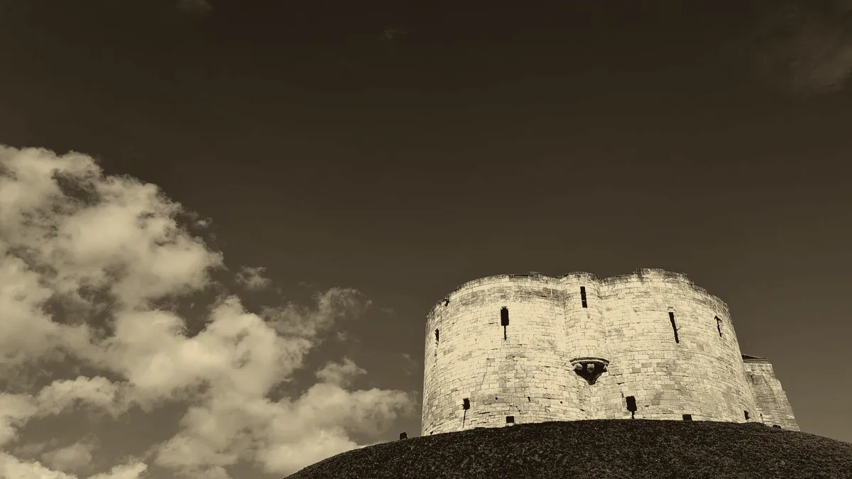 A castle keep rising over the walls.